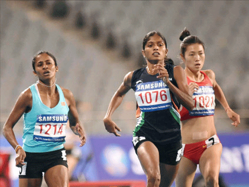 Indian sprinter Tintu Luka(C) clocked her season's best to clinch a silver medal in the 800m women's race of the 17th Asian Games here today. PTI photo