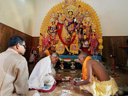 President Pranab Mukherjee performs rituals during Durga Puja at his ancestral house in Birbhum on Wednesday. PTI Photo