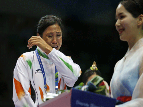 Indian woman boxer Sarita Devi and her cousin Devendro Singh justifiably feel cheated, robbed and deprived of possible gold medals at the Incheon Asian Games. AP file photo