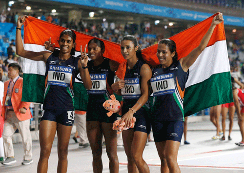 India's Pawar Priyanka, Lukka Tintu, Kaur Mandeep and Poovamma Raju Machettira celebrate winning the women's 4x400m relay final at the Incheon Asiad Main Stadium during the 17th Asian Games October 2, 2014. REUTERS/