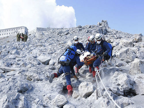 Sixteen people remain unaccounted for on a still-smouldering Japanese volcano that erupted at the weekend, officials said Friday, as a typhoon looming off the coast threatened to further delay the stalled recovery operation. Reuters photo