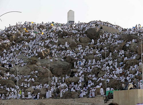 Muslim pilgrims pray on Mount Mercy on the plains of Arafat during the annual haj pilgrimage, outside the holy city of Mecca October 3, 2014. REUTERS