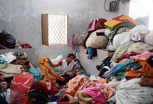 For a  cause:  A worker sorts out donated cotton clothes (above) and makes cloth sanitary napkins at the non-profit organisation 'Goonj' (Echo) in New Delhi. (Below) While MNCs have monopolised the field, minting money in the sanitary business, quite a few social enterprises have been spun out by small entrepreneurs who are making available cheap sanitary napkins. AFP