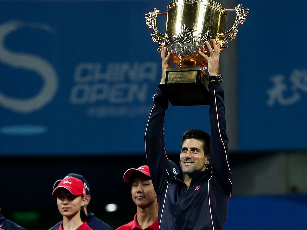 World number one Novak Djokovic destroyed Tomas Berdych in a lop-sided contest to win his fifth China Open crown on Sunday while Maria Sharapova overcame Petra Kvitova 6-4,  2-6, 6-3 in the women's final to move up to number two in the world rankings. Reuters photo