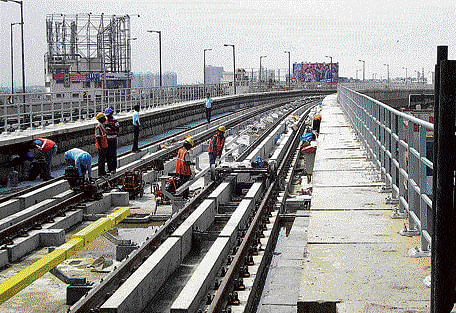 Workers busy laying power supply lines near Jalahalli Metro station, which is likely to be ready for commercial operations by December. dh photo