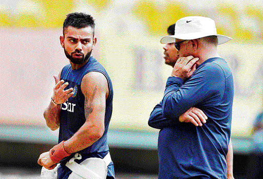 Virat Kohli discusses a point with coach Duncan Fletcher during a practice session on Tuesday. PTI