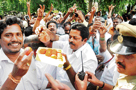 Supporters of former chief minister of Tamil Nadu J Jayalalitha distributed sweets on the High Court premises in Bangalore on Tuesday, after rumours spread that their leader had been granted bail. DH Photo