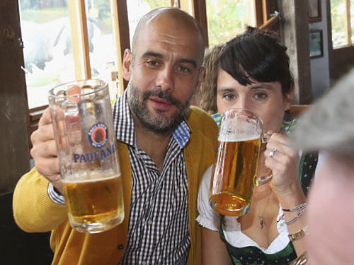 Guardiola, head coach of Bayern Munich, and his wife Cristina attend the Oktoberfest 2014 beer festival in Munich. Reuters photo