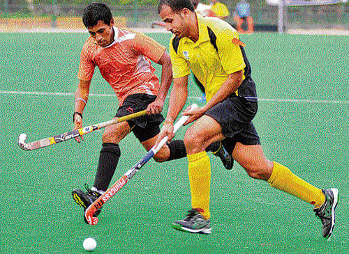 BPCLs Tushar Khandkar (right) attempts to dribble past Arjun Halappa of Air India in the Bengaluru Cup on Saturday. DHphoto