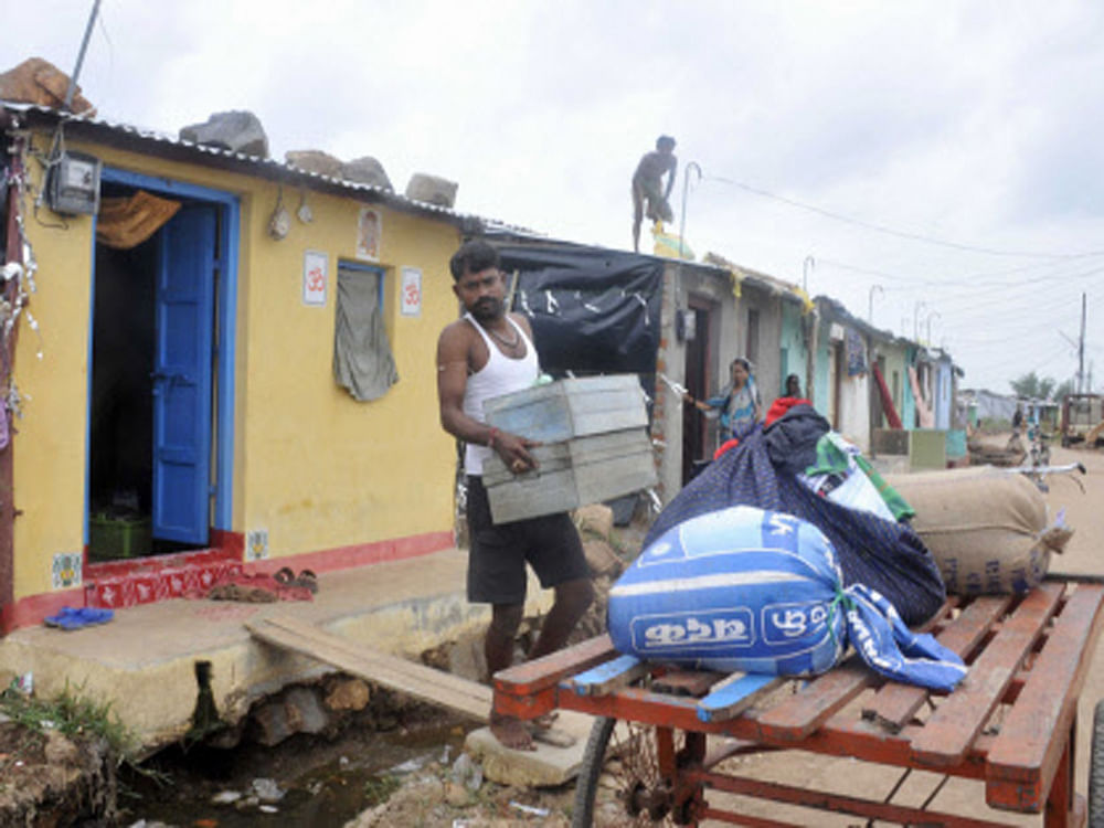 People shift with their valuables from Ghota village after warning of Cyclone Hudhud in Malkangiri district on Saturday. PTI Photo