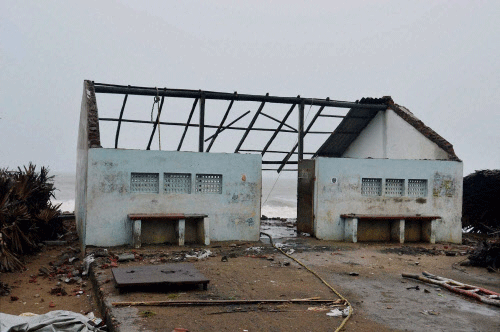 A view of a damaged house due to cyclone Hudhud at Konapapapeta village beach in East Godavari District of Andhra Pradesh on Sunday. PTI Photo