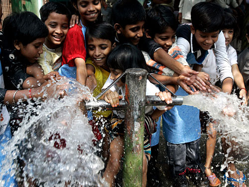 Children wash their hands at a road-side tap during an awareness rally observing Global Hand Wash Day. AP file photo