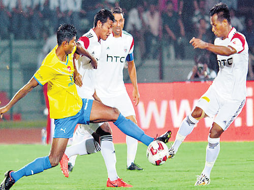 NorthEast United FC and Kerala Blasters' players vie for possession during their ISL clash on Monday. PTI