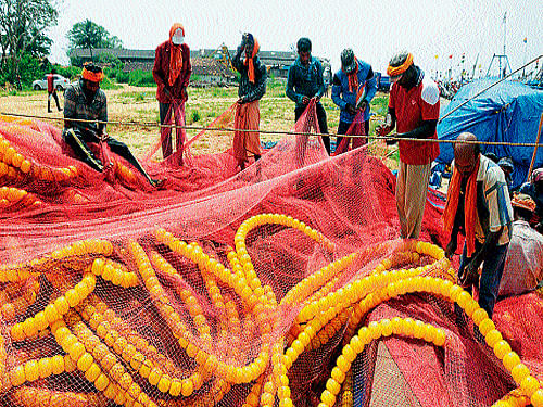 Fishermen keep their fishing nets ready at Bunder in Mangalore on Monday. DH Photo/Govindraj Javali