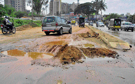 The Hennur Main Road was damaged badly after heavy rains. DH Photo