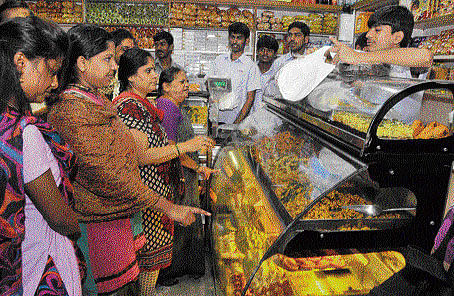 Bustling : The sale of Deepavali sweets is on in full swing. DH Photo by BK Janardhan.