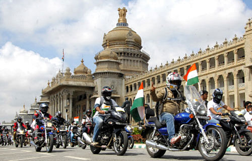 In this file photo, a group of bikers ride past the Vidhana Soudha at building in Bangalore. DH