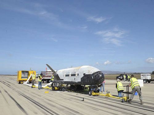 The X-37B Orbital Test Vehicle mission 3 space plane is shown after landing at Vandenberg Air Force Base, California October 17, 2014 in this handout photograph provided by Vandenberg Air Force Base. After spending about 22 months orbiting the Earth on a secret mission, a US Air Force X-37B unmanned, reusable space plane has finally returned. Reuters photo