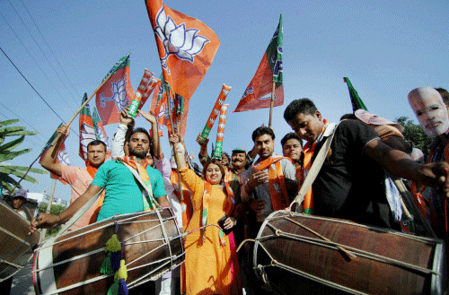 Bharatiya Janata Party supporters celebrate party's victory in the Assembly elections in Haryana and Maharashtra, in Jammu on Sunday. PTI Photo