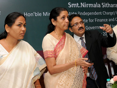 Union Minister of State for Commerce and Industry, Nirmala Sitaraman launching the Online Export permit software, during the interaction meeting with stake holders of Coffee Industry, organised by Coffee Board at Lalit Ashok, in Bangalore on Monday. MP Shobha Karandlaje and Coffee Board Chairman Jawaid Akhtar are seen. DH  Photo: B H Shivakumar