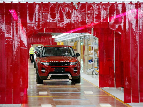 An employee works at the production line inside the Chery Jaguar Land Rover plant before the plant opening ceremony in Changshu, Jiangsu province, October 21, 2014. British luxury carmaker Jaguar Land Rover Ltd, owned by Indian conglomerate Tata group, expects its China sales to grow 20 percent this year, Greater China head Bob Grace said on Tuesday. REUTERS
