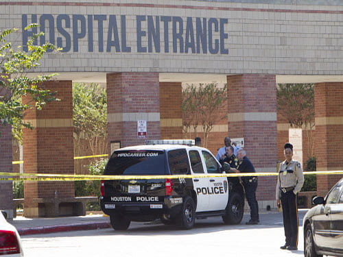 Law enforcement officers stand outside Ben Taub General Hospital following a shooting in the outpatient pharmacy, in Houston. Police say a man walked up to a female co-worker in a Ben Taub Hospital pharmacy and shot her fatally before turning the gun on himself. AP Photo