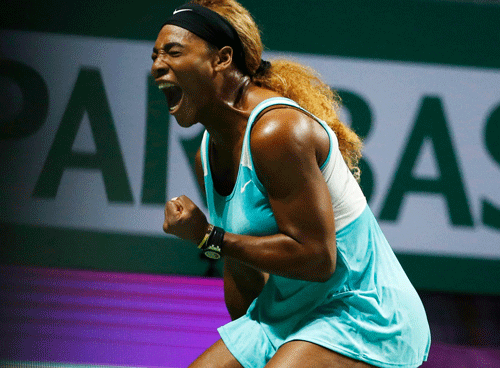 Serena Williams of the U.S. celebrates a point against Eugenie Bouchard of Canada during their WTA Finals singles tennis match at the Singapore Indoor Stadium October 23, 2014. REUTERS