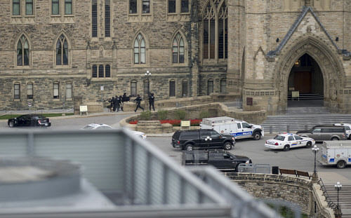 The mother of the man accused of killing a soldier at Ottawa's war memorial then storming Parliament before being shot dead says she is crying for the victims of the shooting, not her son. AP photo