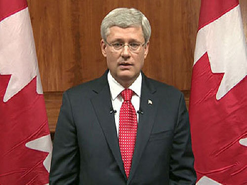 Canadian Prime Minister Stephen Harper was shoved into a closet when a gunmen stormed parliament, local newspapers said today. AP file photo