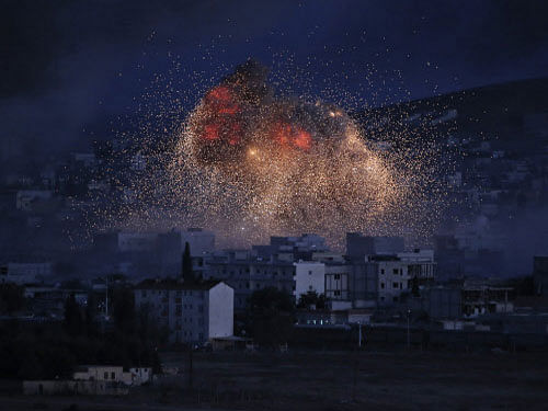 Thick smoke and flames from an airstrike by the U.S.-led coalition rise in Kobane, Syria. Islamic State group fighters made a new bid to cut off the Syrian border town of Kobane from neighbouring Turkey today as preparations gathered pace to deploy Iraqi Kurdish reinforcements. AP photo