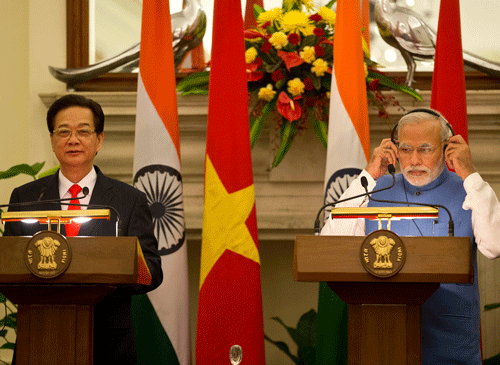 Indian Prime Minister Narendra Modi, right, adjusts a headphone to listen to the translation as Vietnams Prime Minister, Nguyen Tan Dung, speaks during a joint press briefing in New Delhi, India, Tuesday, Oct. 28, 2014. Prime Minister Dung arrived in India Monday on a two day visit. AP Photo