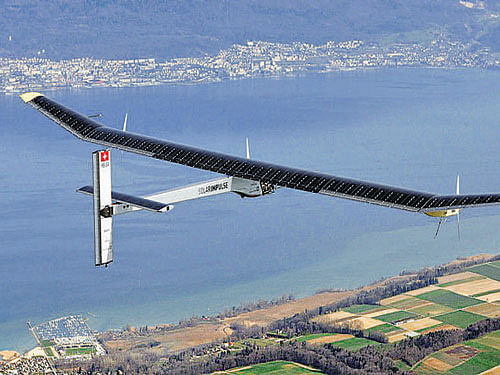 German test pilot Markus Scherdel, steers the solar-powered Solar Impulse HB-SIA prototype airplane during his first flight over the Lake of Neuchatel on April 7, 2010. Reuters