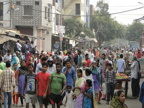 People come out from their houses after curfew was relaxed for few hours in Trilokpuri, in New Delhi on Tuesday. PTI Photo
