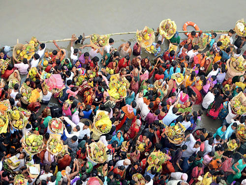 Devotees offer prayers at the bank of Ganga river during Chhath festival in Patna on Wednesday. PTI Photo