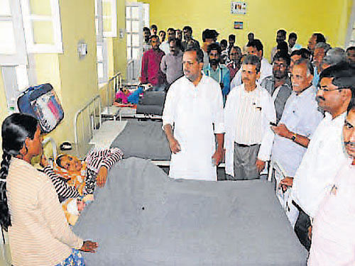 Minister for Health and Family Welfare U T Khader speaks to a patient at Maternity Hospital in Chikmagalur on Thursday.