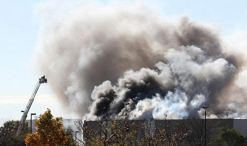 Smoke billows from a building at at Mid-Continent Airport shortly after a twin-turbo airplane crashed into a building, killing several people, including the pilot in Wichita, Kansas October 30, 2014. A small airplane crashed into a building at Mid-Continent Airport in Wichita, Kansas, on Thursday morning, killing at least four people, injuring five and setting off an explosion and fire, officials said. REUTERS