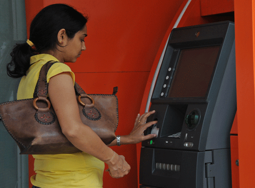 Using ATMs to withdraw money or for other purposes like balance enquiry beyond five times in a month will attract a levy of Rs 20 per transaction from tomorrow. DH file photo