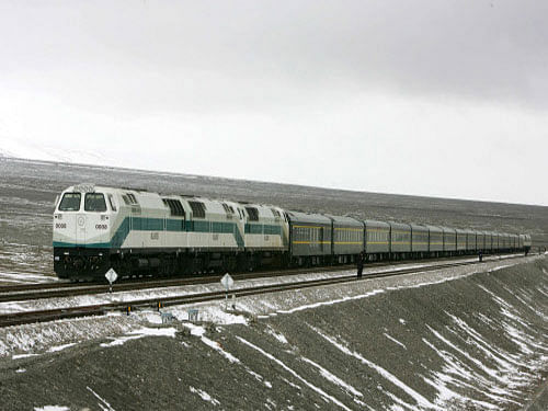 A train runs on the Golmud section of the Qinghai-Tibet Railway beneath Kunlun Mountain in west China's Qinghai province. China today approved construction of a new strategically important high altitude railway line in Tibet costing about USD six billion that would come close to the Indian border in Arunachal Pradesh. Reuters file photo