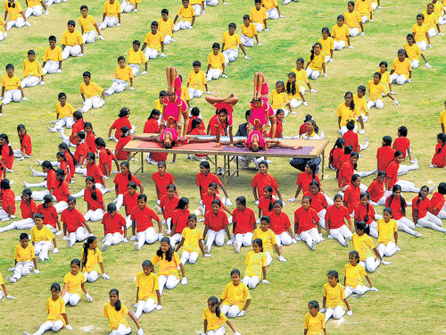 Schoolchildren perform at the Kannada Rajyostava celebration at the Sri Kanteerava Stadiumin the City on Saturday. DH photo/B K Janardhan