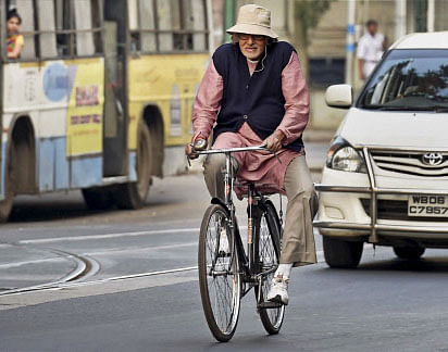Bollywood megastar Amitabh Bachchan rides a cycle during the shooting of his new film 'Piku' in Kolkata on Sunday. PTI Photo