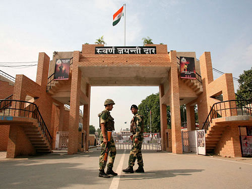 Border Security Force soldiers patrol in front of the golden jubilee gate at the Wagah border, on the outskirts of the northern Indian city of Amritsar. A symbolic Retreat ceremony for the lowering of national flags and closing of border gates took place Monday at the Attari-Wagah joint check post between India and Pakistan following a deadly suicide bombing near Wagah Sunday which left over 60 people dead. Reuters photo