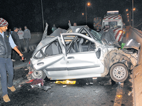 The mangled remains of the car which was rammedby a speeding bus on the Tumkur Road flyover near PeenyaMetro station in the early hours of Monday. DH PHOTO