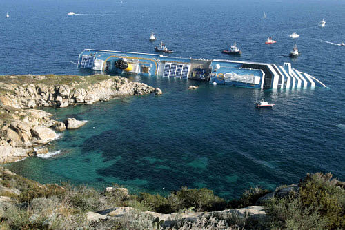 FILE - In this Jan. 14, 2012 file photo the luxury cruise ship Costa Concordia leans on its side after running aground in the tiny Tuscan island of Giglio, Italy. The company dismantling the Costa Concordia cruise ship says workers have discovered human remains believed to be that of the last missing crew member. The Ship Recycling company said the remains were found Monday in a cabin on the ship's eighth deck. The remains were being turned over to Italian authorities for identification. The Concordia capsized after hitting rocks near a Tuscan island in January 2012, killing 32 people. All have been accounted for except an Indian waiter. AP