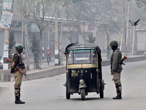 Indian paramilitary soldier interrogate civilians inside an autorickshaw at a temporary check point during curfew in Srinagar, India, Tuesday, Nov. 4, 2014. Parts of the city were under curfew after Indian army soldiers killed two Kashmiris at a check-point in Jammu and Kashmirs Budgam district on Monday. AP Photo