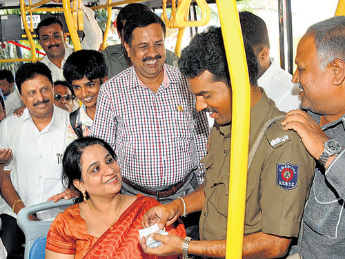 A conductor issues tickets to MLA Krishnappa and BMTCMD Ekroop Caur who travelled fromVijayanagar TTMCto mark Bus Day onWednesday. BMTC Director (Security and Vigilance) G Ramesh is also seen. DH PHOTO
