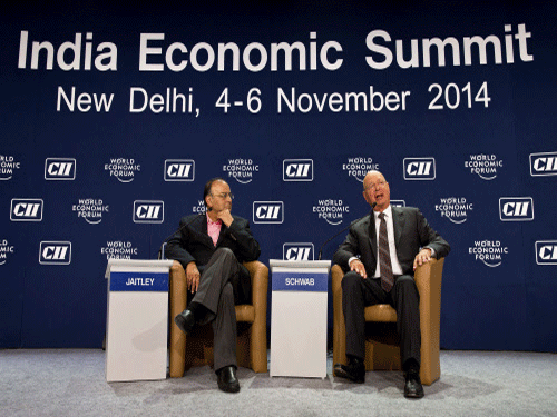 Finance Minister Arun Jaitley, listens to Klaus Martin Schwab, founder and executive chairman of the World Economic Forum, during the opening plenary of India Economic Summit in New Delhi. There may be no 'big bang' reforms, but the new government has set a clear roadmap to put India back on eight per cent plus growth trajectory, business leaders from India and abroad said today. AP photo