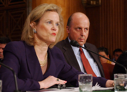 FILE - In this April 7, 2004 file photo, Robin Raphel, coordinator of the State Department's Office of Iraq Reconstruction, discusses the U. N.'s Oil for Food Program on Capitol Hill during an appearance before Senate Foreign Relations Committee. At right, is U. N. Ambassador John Negroponte. The State Department said Thursday, Nov. 6, 2014, that it is cooperating with a law enforcement probe into Robin Raphel, a one-time ambassador to Tunisia and most recently a senior adviser on civilian aid to Pakistan. AP