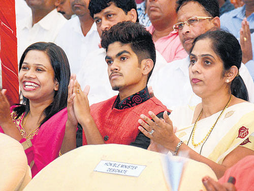 Family members cheer during the swearing-in ceremony as Laxmikant Parsekar (not in the picture) takes oath as the new Chief Minister of Goa in Panaji on Saturday. PTI
