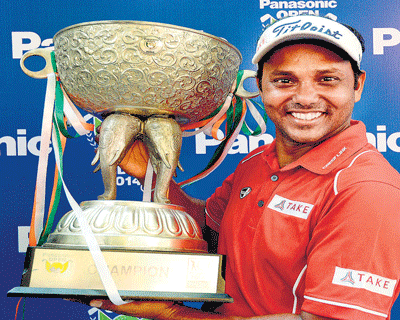 THE CHAMP SSP Chowrasia poses with the trophy after winning the Panasonic Open on Sunday. PTI image