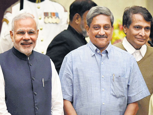 Prime Minister Narendra Modi with newly sworn-in Cabinet ministers Manohar Parrikar and Suresh Prabhu at the oath-taking ceremony at Rashtrapati Bhavan in New Delhi on Sunday. PTI Photo